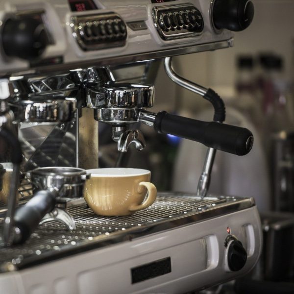 Coffee machine with coffee cup at cafe